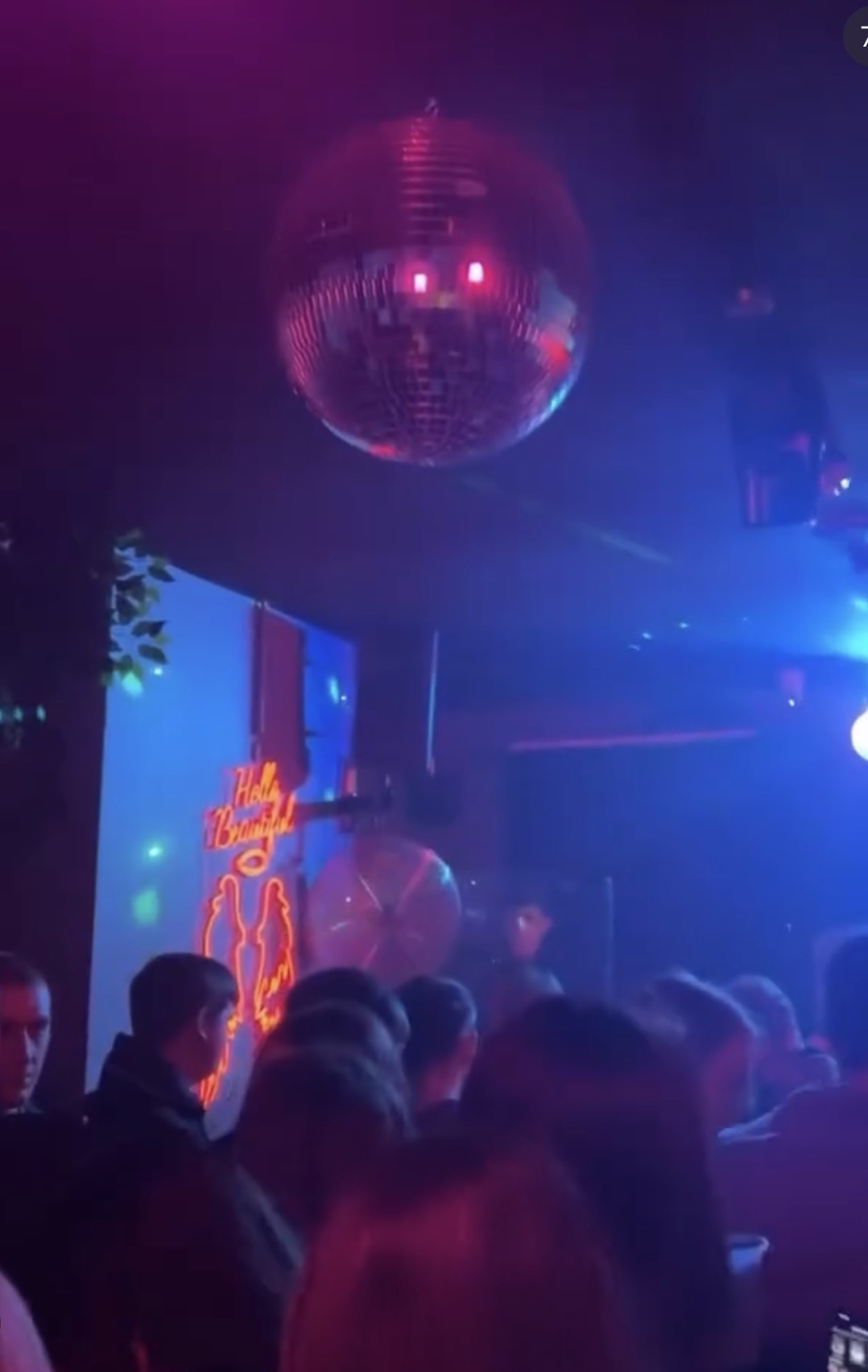 Disco ball above a packed dancefloor